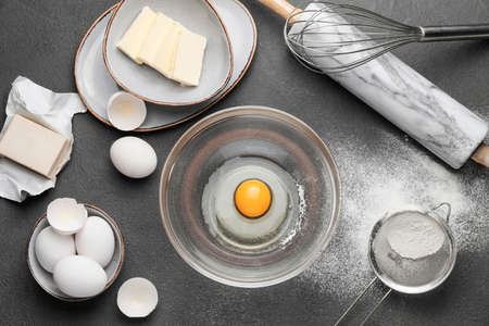Ingredients for dough on dark background