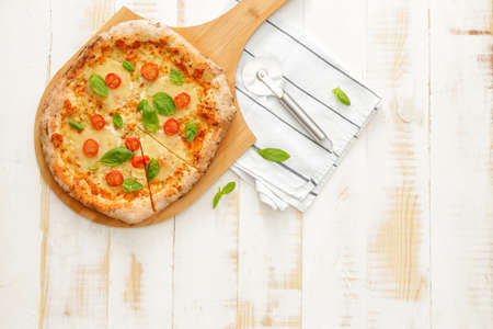 Delicious pizza Margherita on wooden backgroundの写真素材