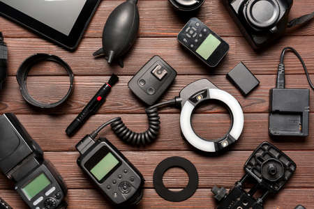 Modern photographer's equipment on wooden backgroundの写真素材