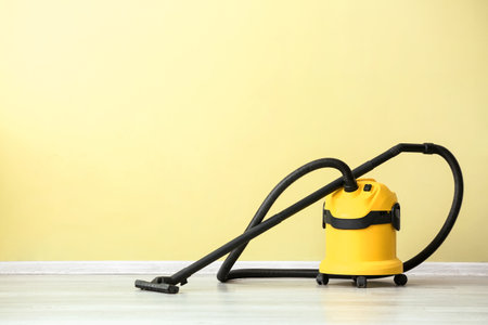 Modern vacuum cleaner near color wallの写真素材
