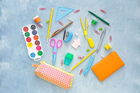 Pencil case and school stationery on color backgroundの写真素材