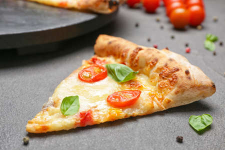 Slice of delicious pizza Margherita on gray backgroundの写真素材