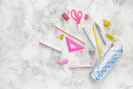 Pencil case and school stationery on light background