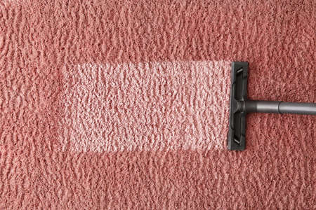 Hoovering of carpet with vacuum cleaner, top viewの写真素材