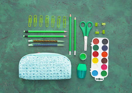 Pencil case and school stationery on color backgroundの写真素材