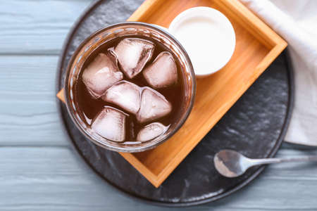 Glass of tasty iced coffee on tableの写真素材
