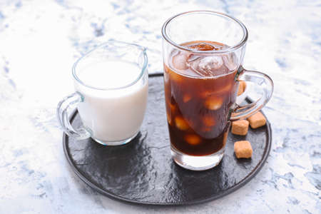 Tasty iced coffee and milk on tableの写真素材