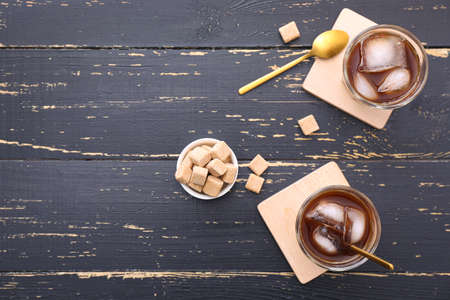 Glasses of tasty cold coffee and sugar on tableの写真素材