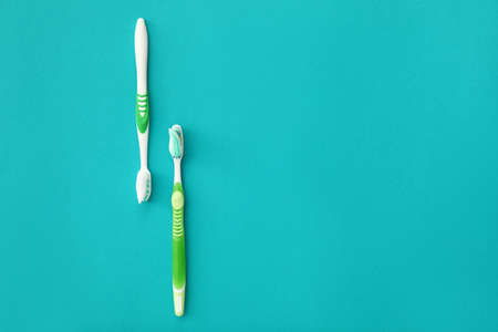 Tooth brushes with paste on color background