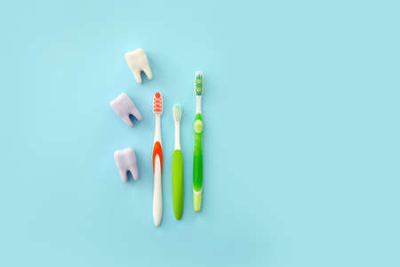 Tooth brushes and plastic teeth on color backgroundの写真素材
