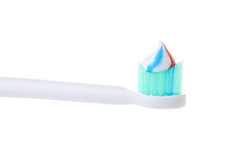 Electric tooth brush with paste on white background