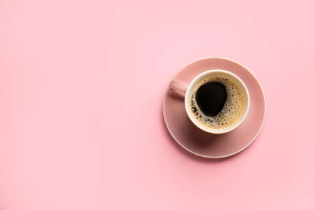 Cup of hot coffee on color backgroundの写真素材