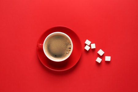 Cup of hot coffee and sugar on color backgroundの写真素材