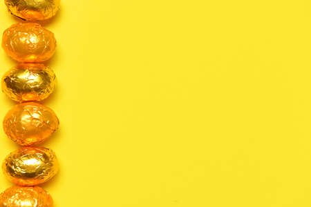 Sweet chocolate eggs on color backgroundの写真素材