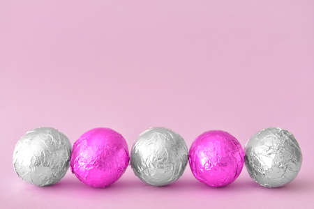 Sweet chocolate eggs on color background