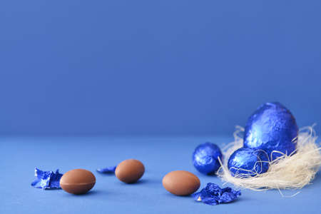Sweet chocolate eggs on color backgroundの写真素材