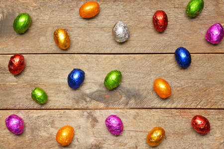 Sweet chocolate eggs on wooden backgroundの写真素材