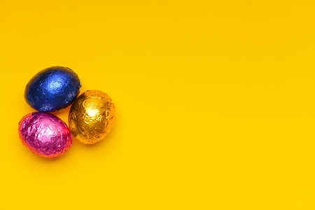 Sweet chocolate eggs on color backgroundの写真素材