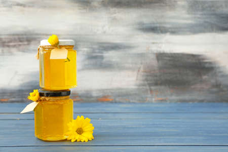 Jars of sweet honey on tableの写真素材