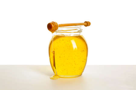 Jar of sweet honey on white backgroundの写真素材