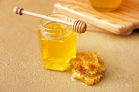 Jar of sweet honey on table