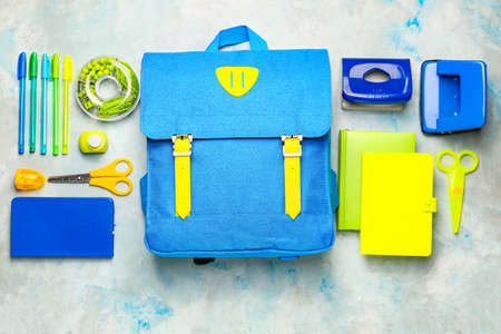 School backpack and stationery on color backgroundの写真素材