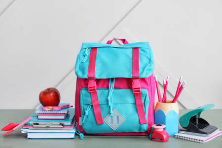 School backpack and stationery on wooden tableの写真素材