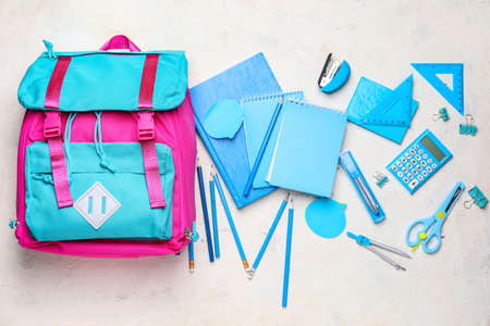 School backpack and stationery on white backgroundの写真素材