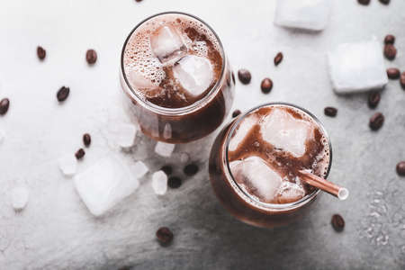 Glasses of tasty iced coffee on tableの写真素材