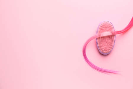 Hair brush and strand on color backgroundの写真素材