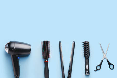 Set of hairdresser's accessories on color backgroundの写真素材