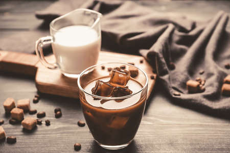 Glasses of tasty iced coffee and milk on tableの写真素材