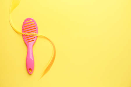 Hair brush and strand on color backgroundの写真素材
