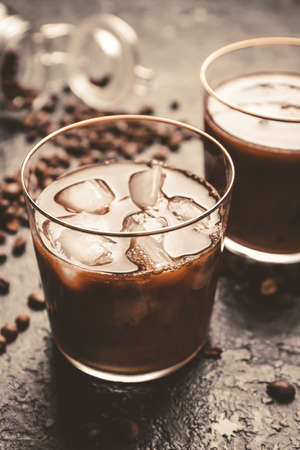 Glasses of tasty iced coffee on table