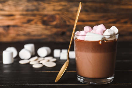Glass of hot chocolate with marshmallows on tableの写真素材