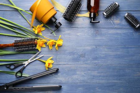 Set of hairdresser's accessories on color wooden background