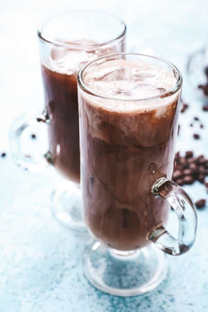Glasses of tasty iced coffee on table