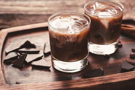 Glasses of tasty iced coffee on tableの写真素材