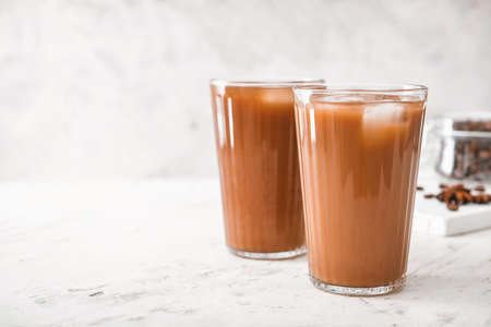 Glasses of tasty iced coffee on tableの写真素材