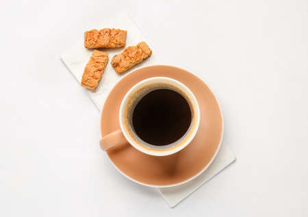 Cup of hot coffee and cookies on white backgroundの写真素材