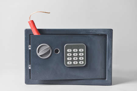 Modern safe with dynamite on light backgroundの写真素材