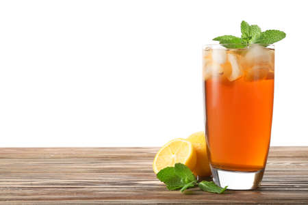 Glass of tasty cold ice tea on table against white backgroundの写真素材
