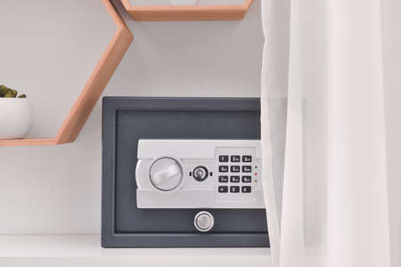 Modern safe on shelf in roomの写真素材