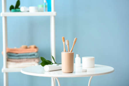 Tooth brushes in holder on table in bathroomの写真素材