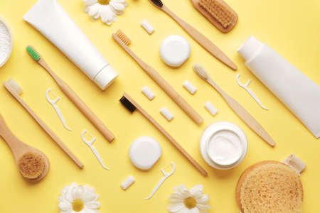 Tooth brushes with bath supplies on color background