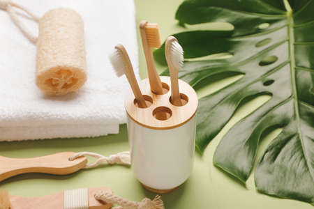 Tooth brushes with bath supplies on color backgroundの写真素材