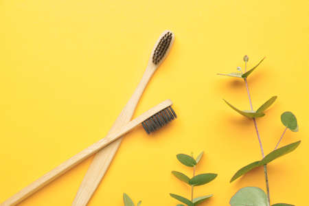 Wooden tooth brushes on color backgroundの写真素材