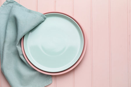 Clean napkin with plates on wooden backgroundの写真素材