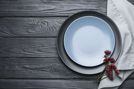 Clean napkin with plates on wooden backgroundの写真素材