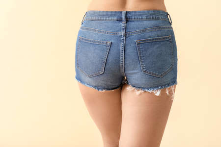 Young woman with cellulite problem on color backgroundの写真素材